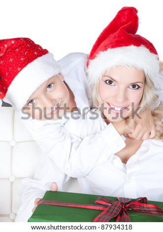 Bright picture of happy mother and little son dressing in Santa\'s Helper hat with gift over white
