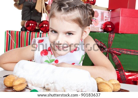Cute little girl holding Christmas cake with powdered sugar over white