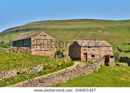Picturesque old stone barns on a farm in the rolling hills of the Yorkshire Dales, England