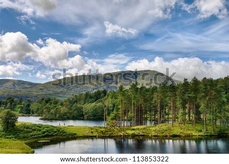 A view of Tarn Hows, a small lake in the English Lake District with Wetherlam in the background