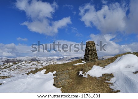 The snow streaked summit and tig point of Brunt Knott, a hill in the English lake District