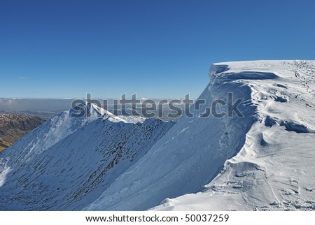 Scenic view of snow covered Helvellyn mountain summit in Winter, Lake District National Park, Cumbria, England.