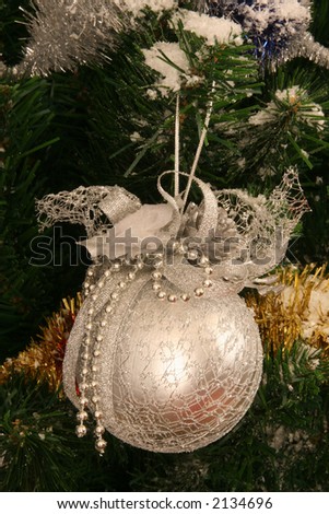 Silver sphere on a christmas fir-tree