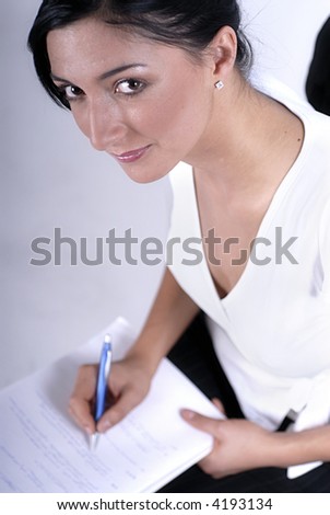Picture of woman handwriting notes with blue pen.