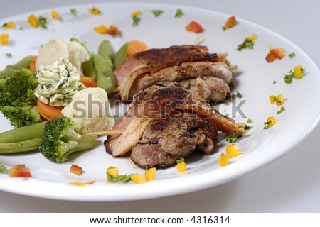 Picture of pork steak with man and vegetables on plate.