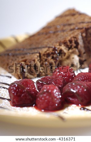 Dessert - chocolate cake with raspberries and chocolate topping.