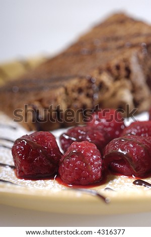 Dessert - chocolate cake with raspberries and chocolate topping.