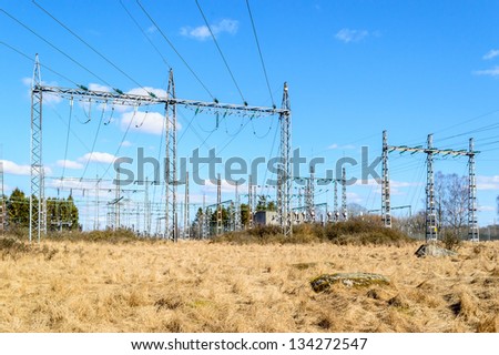 Power grid and transformation of electricity. Blue skies with white clouds.