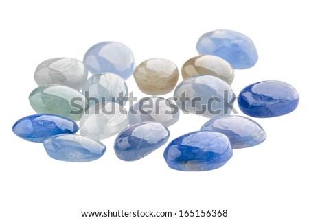 A pile of blue sapphire cabochons on white