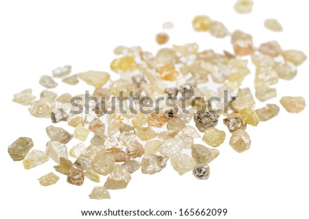 A pile of raw, uncut natural diamonds on white