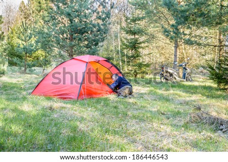 KALMAR, SWEDEN - APRIL 04, 2014: Man organizes Hilleberg tent for sleepover in Swedish nature in early spring.