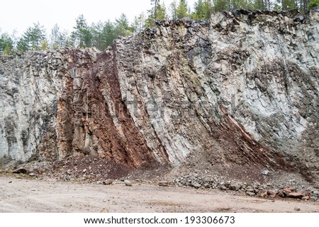 Old limestone quarry with vertical layered sedimentation. Vertical layers caused by meteorite impact 377 miljon years ago.