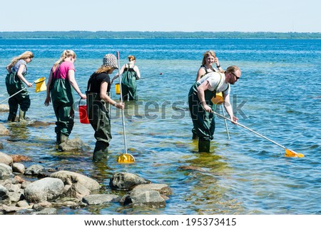 KALMAR, SWEDEN - MAY 26, 2014: Group examining water with ring nets on ecology excursion.