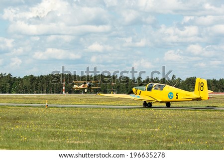 KALLINGE, SWEDEN - JUNE 01, 2014: Swedish Air Force air show 2014 at F 17 Wing. SAAB 91 Safir, Sapphire, Team sk-50. On the ground. Tummelisa in air.