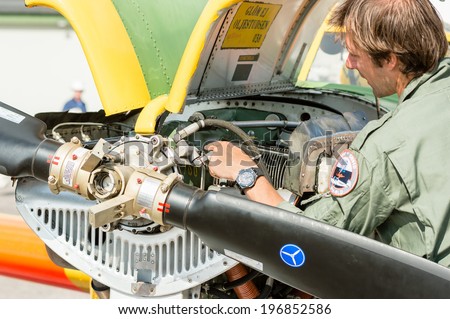 KALLINGE, SWEDEN - JUNE 01, 2014: Swedish Air Force air show 2014 at F 17 Wing. Saab 91 Safir. Personnel doing engine check.