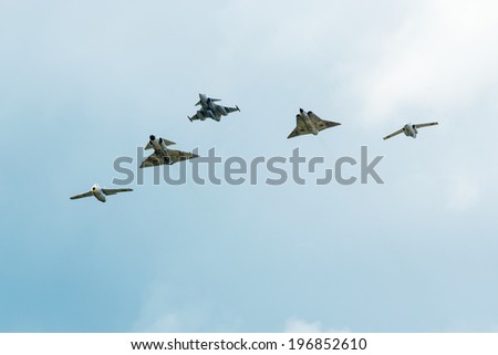 KALLINGE, SWEDEN - JUNE 01, 2014: Swedish Air Force air show 2014 at F 17 Wing. Five of Swedens flying jets in formation. Tunnan, Viggen, Gripen, Draken and 105, all Saab.