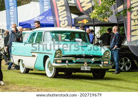RONNEBY, SWEDEN - JUNE 28, 2014: Nostalgia Festival with classic cars and motorcycles as main attractions. Plymouth Ser 62 Cab driving on grass lawn.