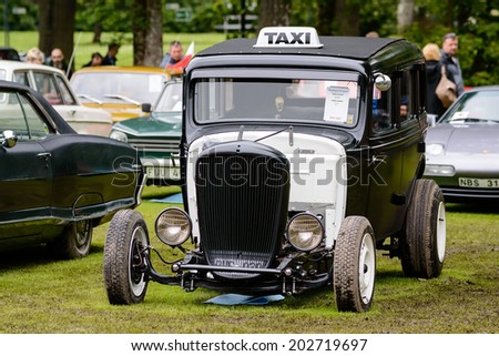 RONNEBY, SWEDEN - JUNE 28, 2014: Nostalgia Festival with classic cars and motorcycles as main attractions. Essex Terraplane six 1933 as black and white taxi hot rod.
