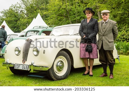 RONNEBY, SWEDEN - JUNE 28, 2014: Nostalgia Festival with classic cars and motorcycles as main attractions. Senior couple beside their Lea Francis Mark six Saloon 1949.