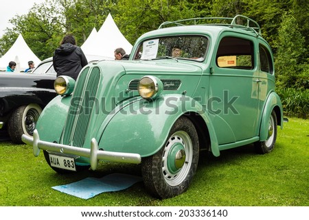 RONNEBY, SWEDEN - JUNE 28, 2014: Nostalgia Festival with classic cars and motorcycles as main attractions. Green Ford Anglia tudor 1950.