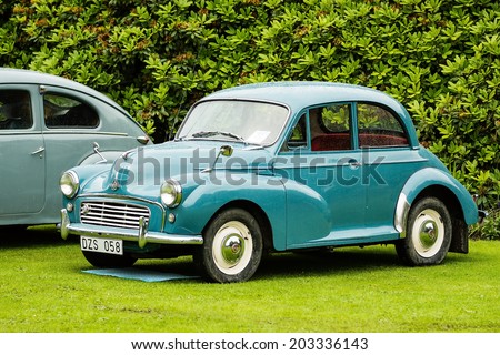 RONNEBY, SWEDEN - JUNE 28, 2014: Nostalgia Festival with classic cars and motorcycles as main attractions. Green Morris minor 1000 1960.