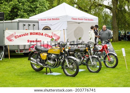 RONNEBY, SWEDEN - JUNE 28, 2014: Nostalgia Festival with classic cars and motorcycles as main attractions. Three motorcycles on exhibition at Classic Honda club.