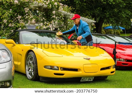 RONNEBY, SWEDEN - JUNE 28, 2014: Nostalgia Festival with classic cars and motorcycles as main attractions. Yellow corvette being dryed from rain water.