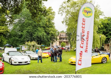 RONNEBY, SWEDEN - JUNE 28, 2014: Nostalgia Festival with classic cars and motorcycles as main attractions. Club Corvette Sweden showing cars in area in front of old house.