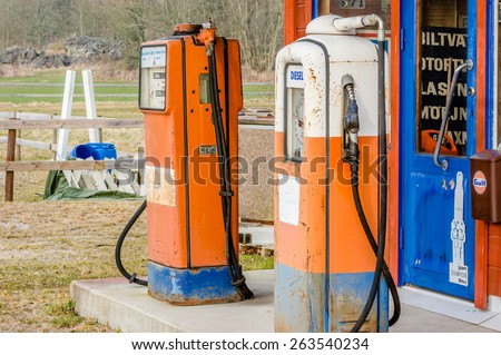 EDESTAD, SWEDEN - MARCH 24, 2015: Vintage Gulf gasoline station replica with diesel pump still in working order. Blue door on station is closed. Pumps are rusty.