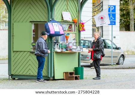 KARLSHAMN, SWEDEN - MAY 06, 2015: Two unknown senior persons outside lottery kiosk in central Karlshamn.