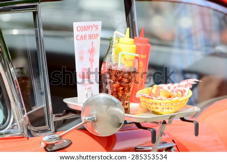BJORKERYD, SWEDEN - JUNE 07, 2015: Tray with food and drink on red car. Part of small local veteran car show.