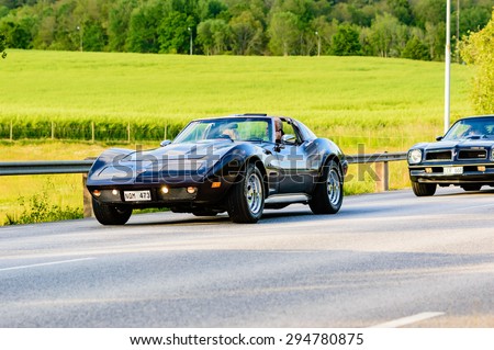 RONNEBY, SWEDEN - JUNE 26, 2015: Veteran car street cruise on public roads. Dark blue Chevrolet Corvette 1974.