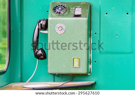 An old telephone from inside a telephone booth from the 1970s. The mobile phone of the old age. This is a Swedish model with the old emergency or SOS number.