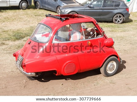 Cheshire, UK  - August 5th 2015.A classic red bubble car with an open sunroof at a classic car rally