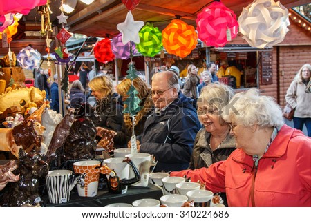 Manchester,England - November 16th 2015:Manchester Christmas market stall busy with female visitors looking at Christmas decorations.