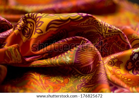red, yellow, orange tender colored textile, elegance rippled material, fabric and tissue