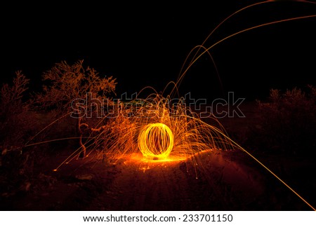 fire painting, light painting with sparks at winter