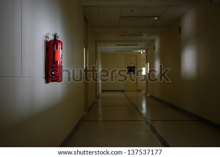 Fire extinguisher in dimly lit corridor