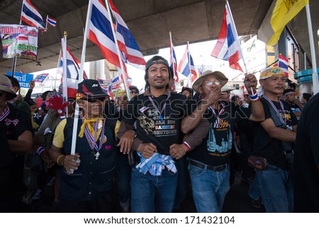 JANUARY 13, 2014 - BANGKOK : Anti-government protesters link arms as they rally through downtown Bangkok on January 13, 2014.