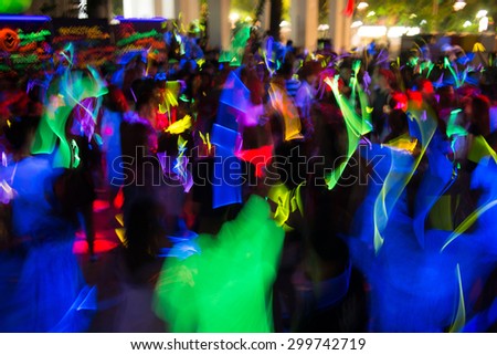 People dancing in a glow in the dark party