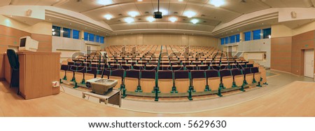 Panorama - strength in numbers. Seats in a lecture hall with projector and computer