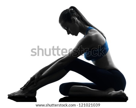 one caucasian woman exercising yoga sitting stretching in silhouette studio isolated on white background