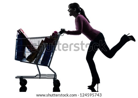 one caucasian woman with full shopping cart in silhouette studio isolated on white background