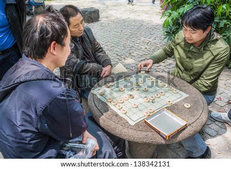 SHANGHAI - APRIL 7: people playing chinese chess in people\'s park  at the city of Shanghai in China on april 7th, 2013