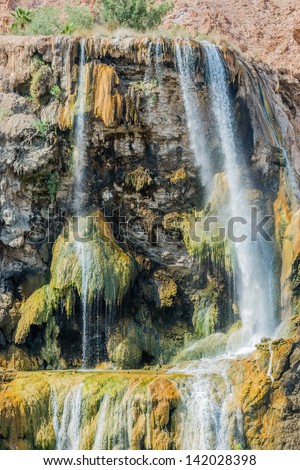 one woman bathing at ma\'in hot springs waterfall  in jordan middle east