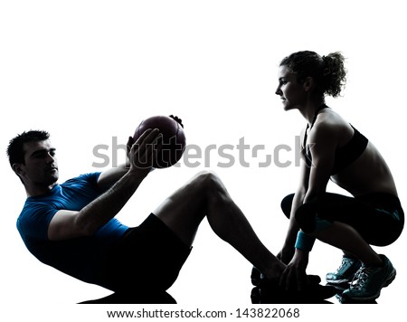 One Caucasian Couple Man Woman Personal Trainer Coach Exercising Weights Fitness Ball Silhouette Studio Isolated On White Background