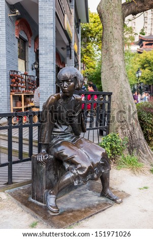 statue of ding ling (social activist and writer ) in pedestrian way of duolon road  at the city of Shanghai in China