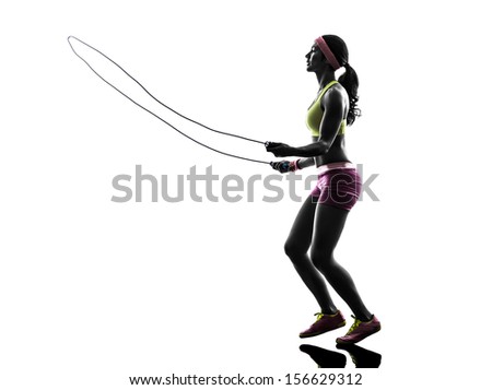 one caucasian woman exercising fitness  jumping rope  in silhouette on white background - stock photo