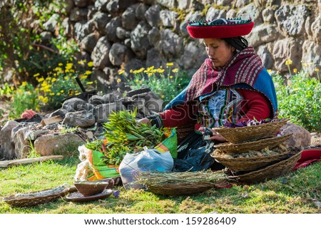 CUZCO, PERU - JULY 15: woman with natural dyes in the peruvian Andes at Cuzco Peru on july 15th 2013.  In the Andes of Peru every village has its own weaving patterns and traditions.