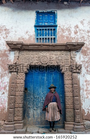 MORAY, PERU - JULY 15: woman in front of ancient door in the peruvian Andes at Moray in Cuzco Peru on july 15, 2013. Moray is located approximately 50km NW of Cuzco on a high plateau at about 3500masl